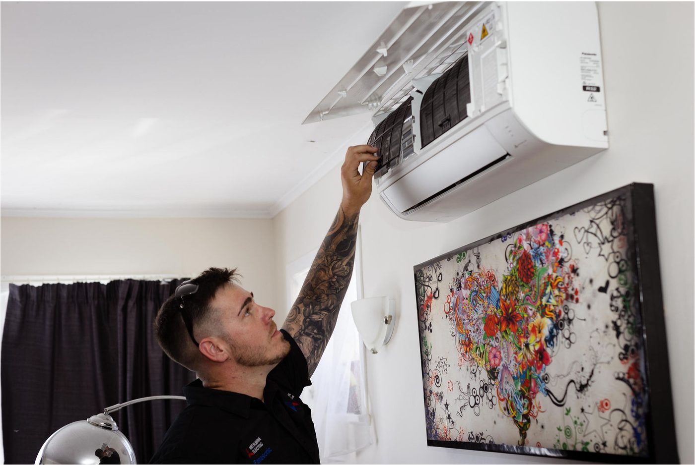 Ben from Simpson Climate Control servicing a Panasonic heat pump in an Auckland home